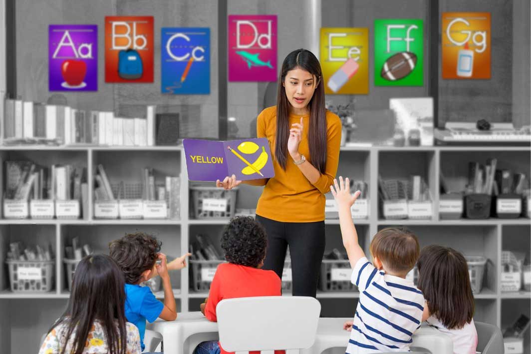 A teacher reading to her class in front of alphabet posters set in Summitsoft fonts